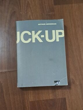 UCK-UP paperback book in gray and cream